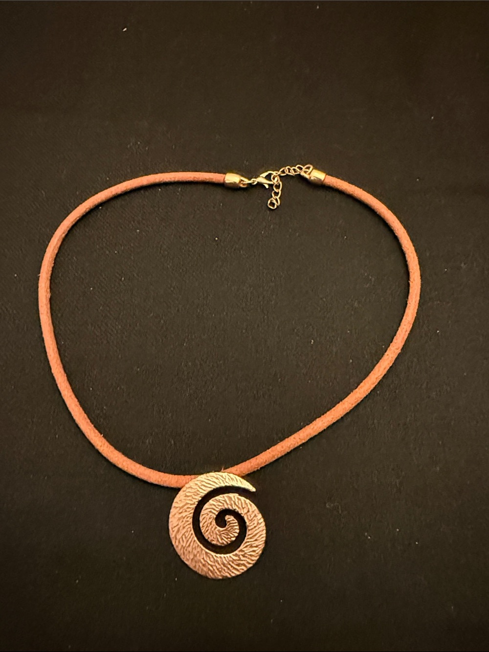 Spiral Pendant Necklace in bronze with cayenne colored corded necklace.